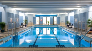 An indoor swimming pool with clear lanes, safety signs, and lounge chairs. - Windermere Manor Hotel (Windermere)