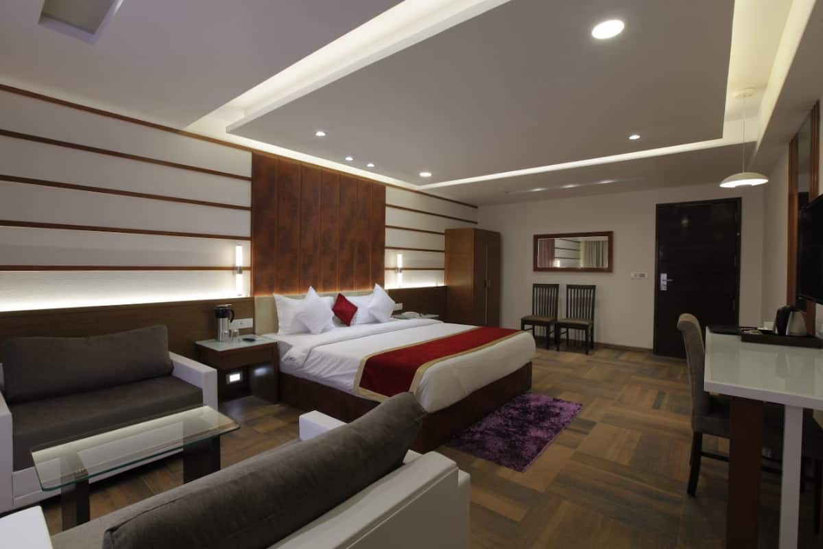 Superior Suite, 1 King Bed | Living room | 32-inch flat-screen TV with cable channels, TV