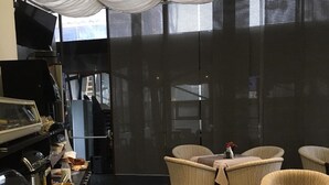 A dining area with a buffet setup, including a fruit bowl on a table with a menu.