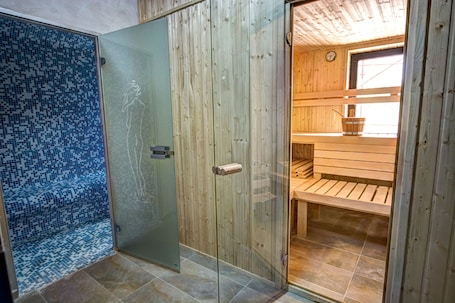 A wooden interior with a glass shower enclosure and a wooden bench.
