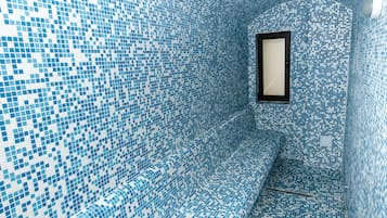 Stunning interior design with a distinctive blue mosaic tile pattern and bench.