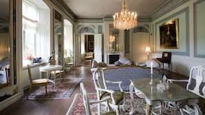 A formal dining room with ornate furniture, a chandelier, and a fireplace. - Husby Säteri (Soderkoping)
