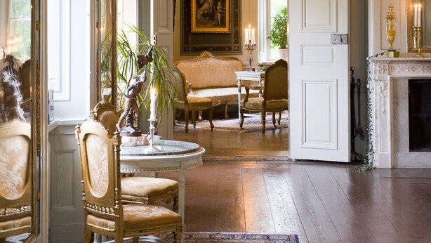A grand room with a large mirror, ornate furniture, and a fireplace. - Husby Säteri (Soderkoping)