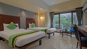 A hotel room with two beds, a desk, and a chair. - Treebo Regency - Bund Garden, Dhole Patil Road (Pune)