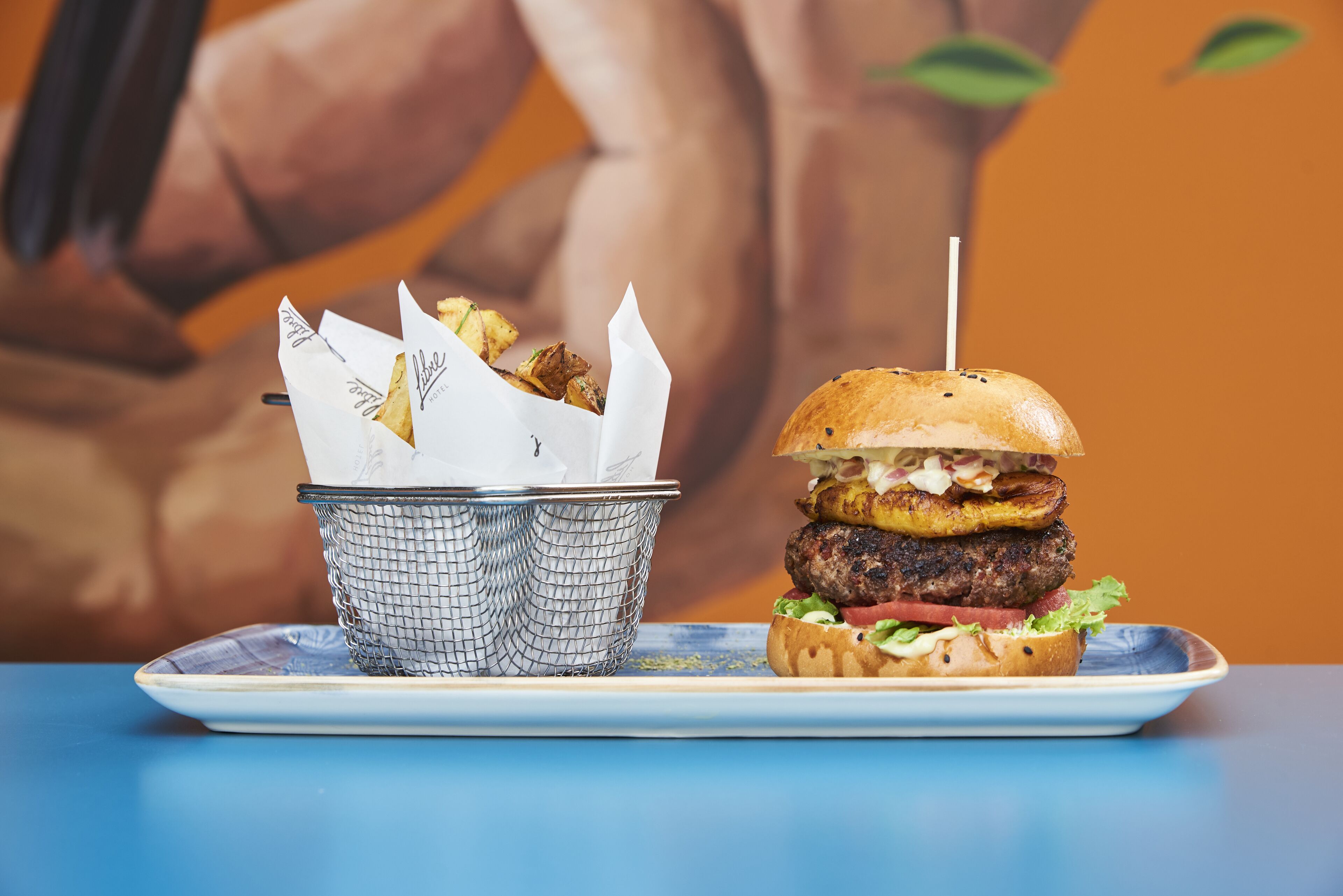 A burger with a side of fries on a plate.