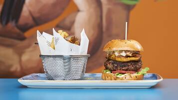 A burger with a side of fries on a plate.
