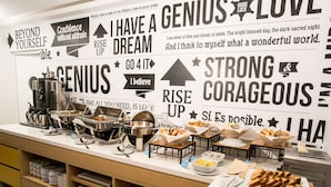 A buffet setup with various food items and motivational quotes on the wall. - Libre Hotel, BW Signature Collection (Lima)