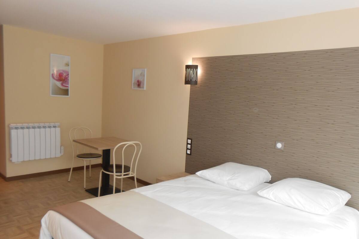 Ein Hotelzimmer mit einem Bett, einem Schreibtisch und einem Stuhl.