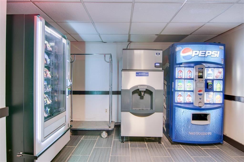 A vending machine and a self-service beverage dispenser in a commercial setting.