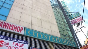 A CityState Hotel with a sign for a pawnbroker and a free Wi-Fi access sign. - Bedbox Hotel (Manila)