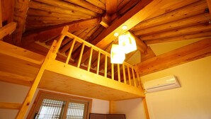 A wooden interior with a balcony, a ceiling fan, and an air conditioning unit. - The Mumum (Jeonju)
