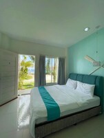 Un dormitorio con una cama, ventilador de techo y vistas al exterior.