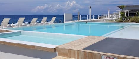 Outdoor pool, open 7:00 AM to 10:00 PM, pool loungers