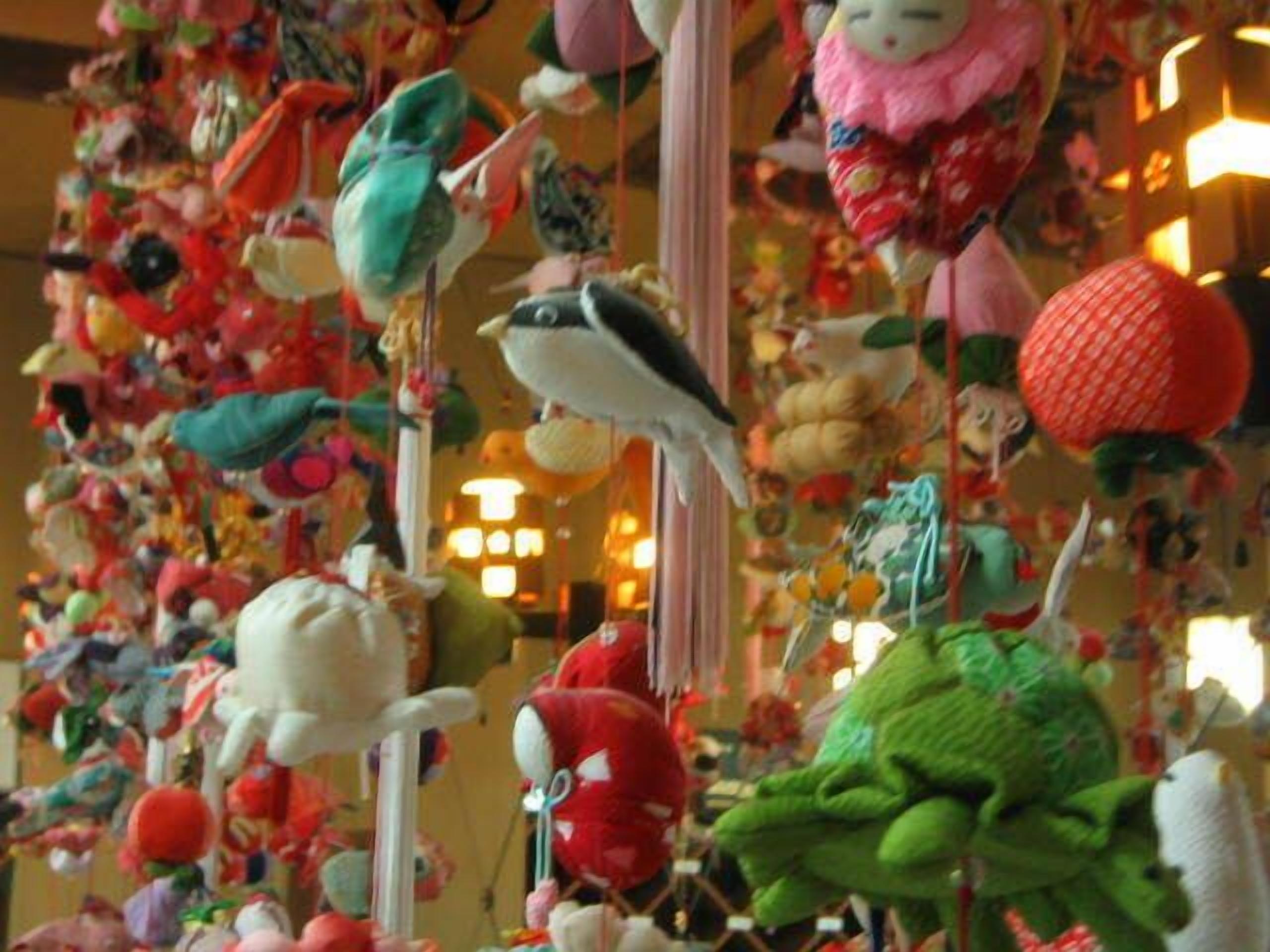 A room filled with various stuffed animals and toys hanging from the ceiling.