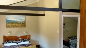 Une chambre à coucher avec un lit, un canapé et un tableau accroché au mur.