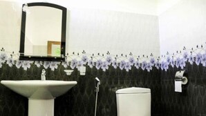 Un baño con un lavabo blanco, un inodoro y un espejo.