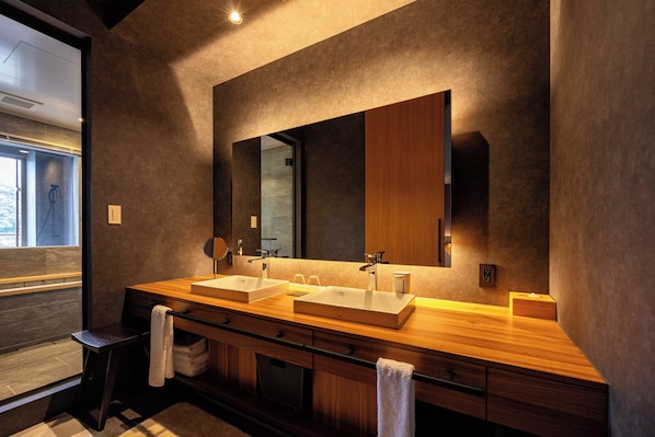 A modern bathroom with two sinks, a large mirror, and a wooden vanity. - URARI TAKEO GARDEN TERRACE SPA RESORTS (Takeo)