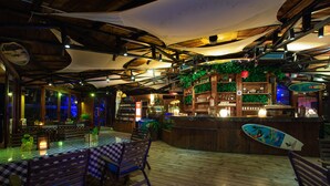 An indoor bar area with wooden flooring, checkered tablecloths, and wooden chairs. - Da Mei Sha Yacht Club Resort (Shenzhen)
