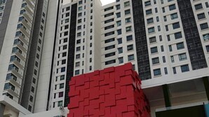 A modern high-rise building with a prominent red cube structure in the foreground. - Elegant Cube Soho One South (Seri Kembangan)