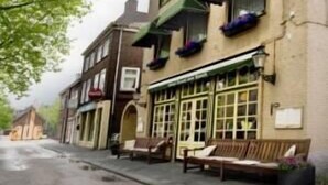 A hotel with a green awning, outdoor seating, and a sign indicating it is a hotel. - Hotel Jo van den Bosch ('s-Hertogenbosch)