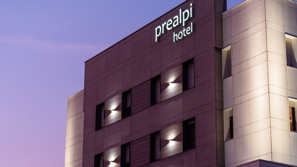 A modern hotel building with a sign reading "prealpi hotel." - Prealpi Hotel (San Vendemiano)
