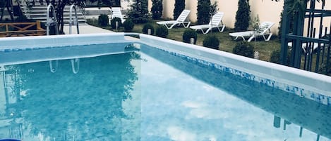 Seasonal outdoor pool, pool loungers