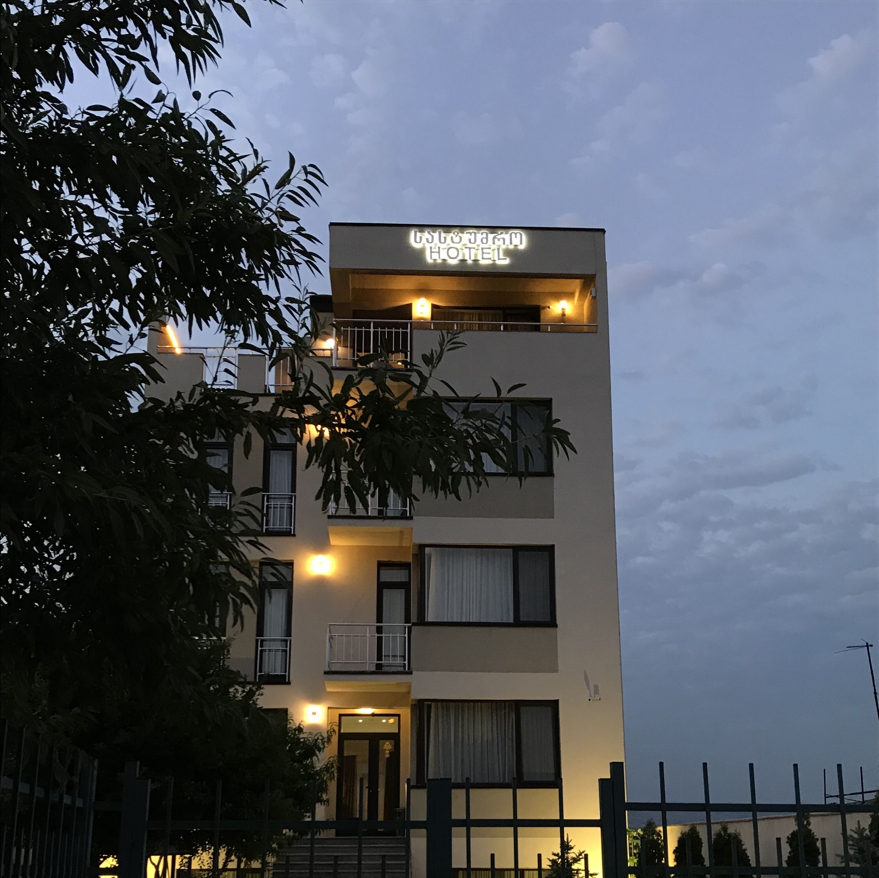 A modern hotel with a sign reading "CST Hotel".
