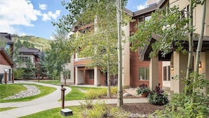 A residential area with modern houses, a curved driveway, and well-maintained landscaping.