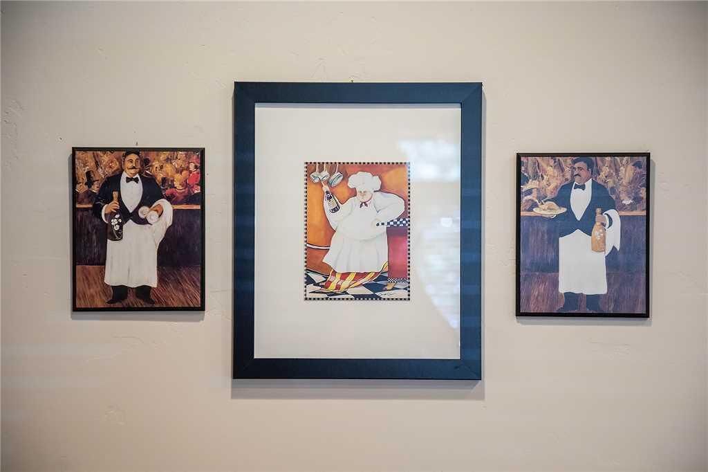 Three framed artworks on a wall.