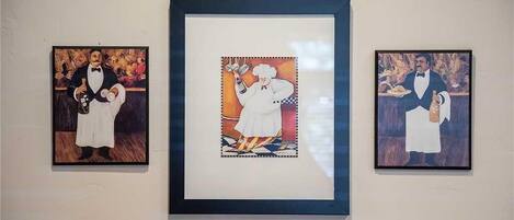 Three framed artworks on a wall.