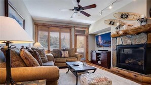A living room with a sofa, coffee table, and fireplace.