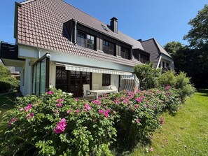 A two-story house with a covered patio area.