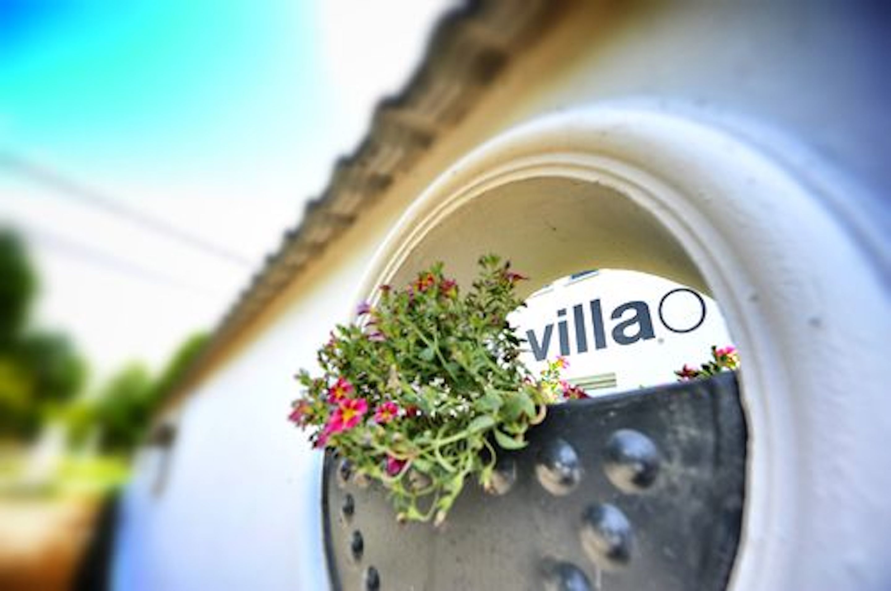 A mailbox with a 'villa' sign and a flower arrangement.