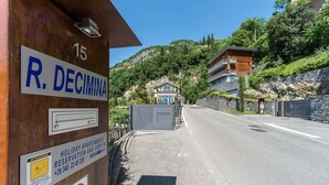 A hotel entrance with a sign for R. Decimina, a contact number, and a no parking sign. - Residenza Decimina (Perledo)
