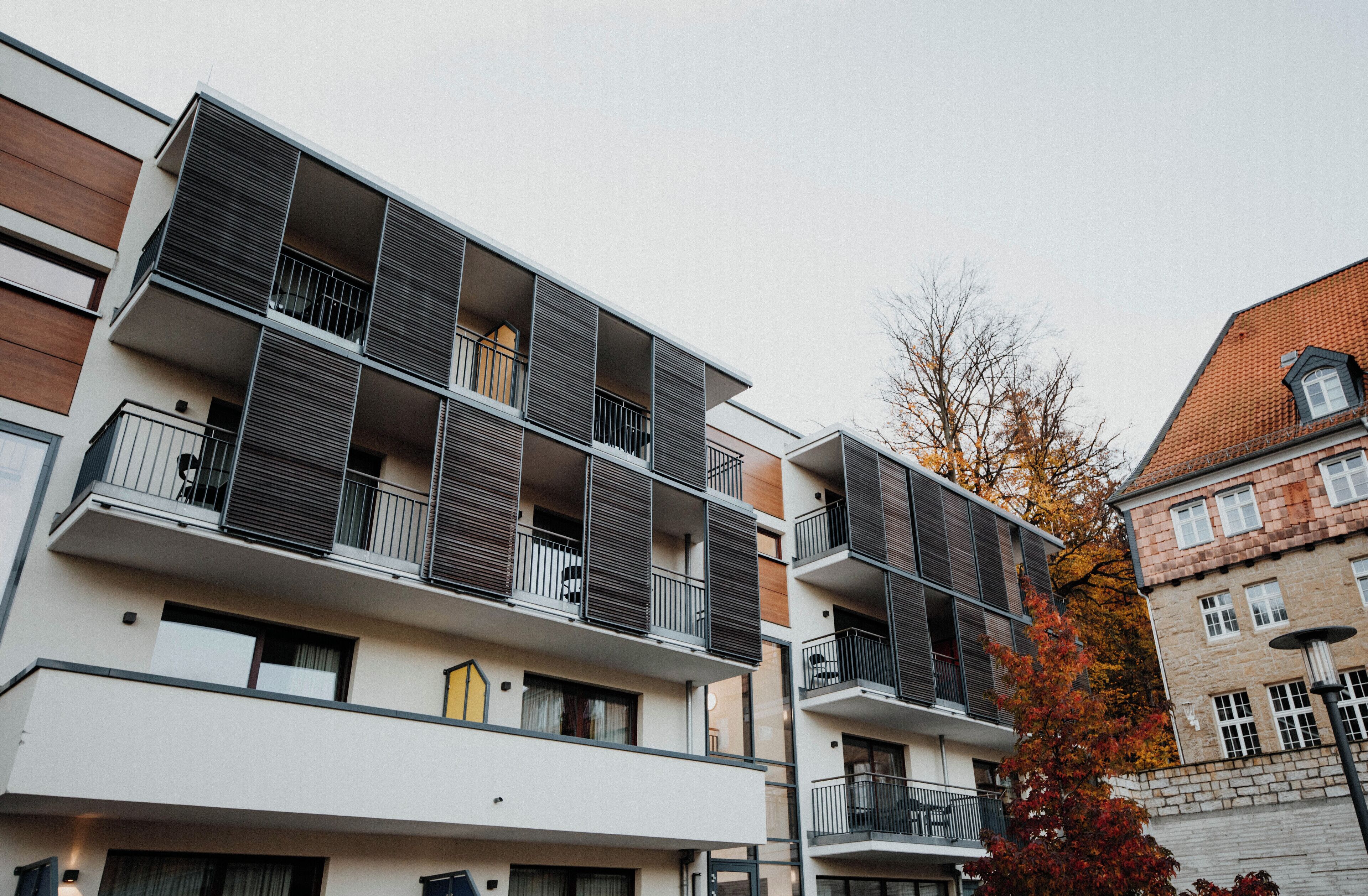 A multi-story residential building with balconies and a mix of architectural styles.