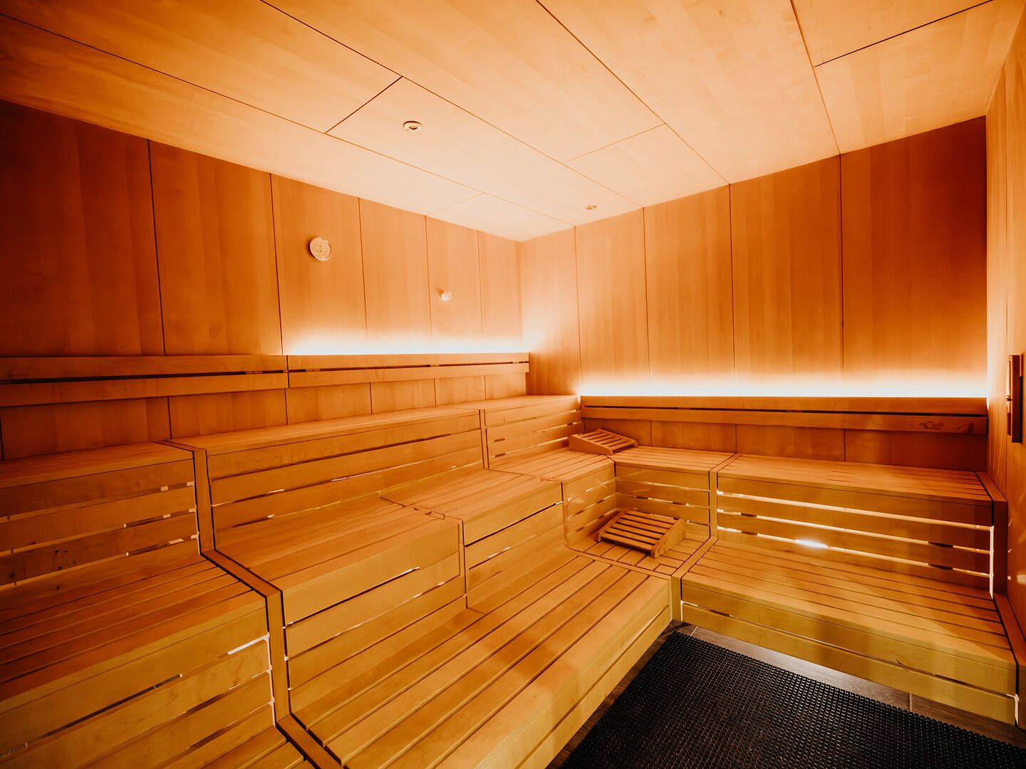 A sauna with wooden benches and a glass floor.