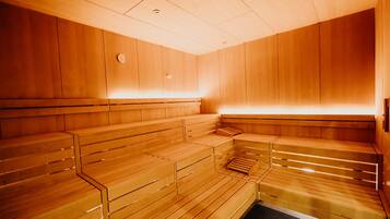A sauna with wooden benches and a glass floor.