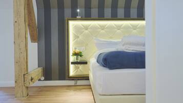 A bedroom with a bed, bedside table, and a mirror.