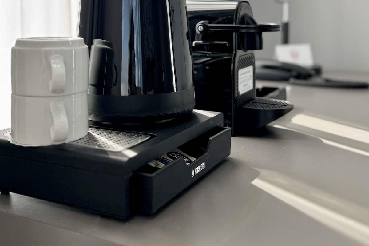 A coffee machine with a cup on the counter.