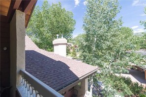 A balcony with a tiled roof overlooking a residential area with trees and houses. - 1310 Trappeur's Lodge, Trappeur's Crossing Apartment 3 (Steamboat Springs)