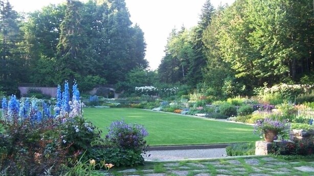 A well-maintained garden with a variety of plants and a stone pathway leading through it. - Super Clean, Fully-Equipped Private Suite 1 Mile from Acadia (Bar Harbor)