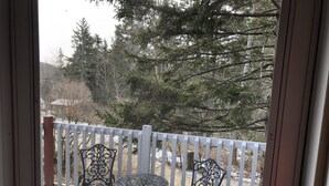 A screened porch with two ornate metal chairs and a small round table. - Super Clean, Fully-Equipped Private Suite 1 Mile from Acadia (Bar Harbor)