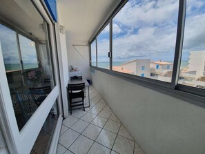 Relax on the balcony with a morning coffee, taking in views of the surrounding buildings and the sea.
