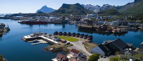 A coastal town with a marina, residential buildings, and a large ship docked.