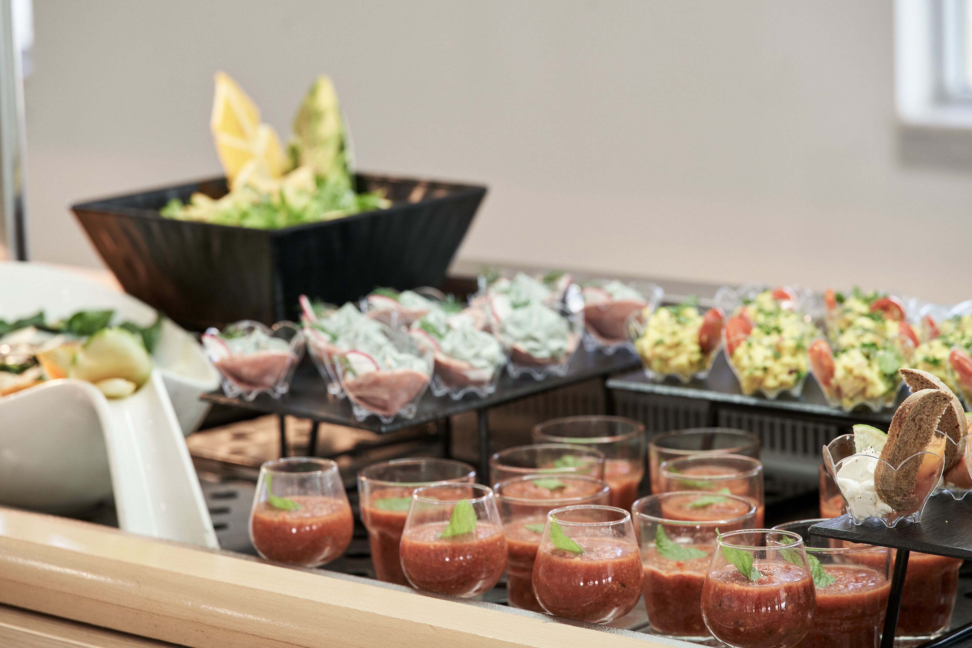 A buffet with various food items and drinks.