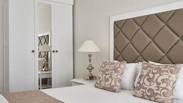 A bedroom with a bed, a nightstand, a lamp, and a wardrobe.