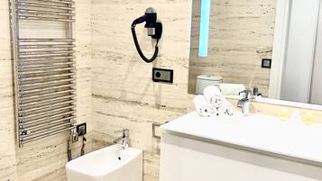 A modern bathroom with a bidet, a large mirror, and a towel rack.