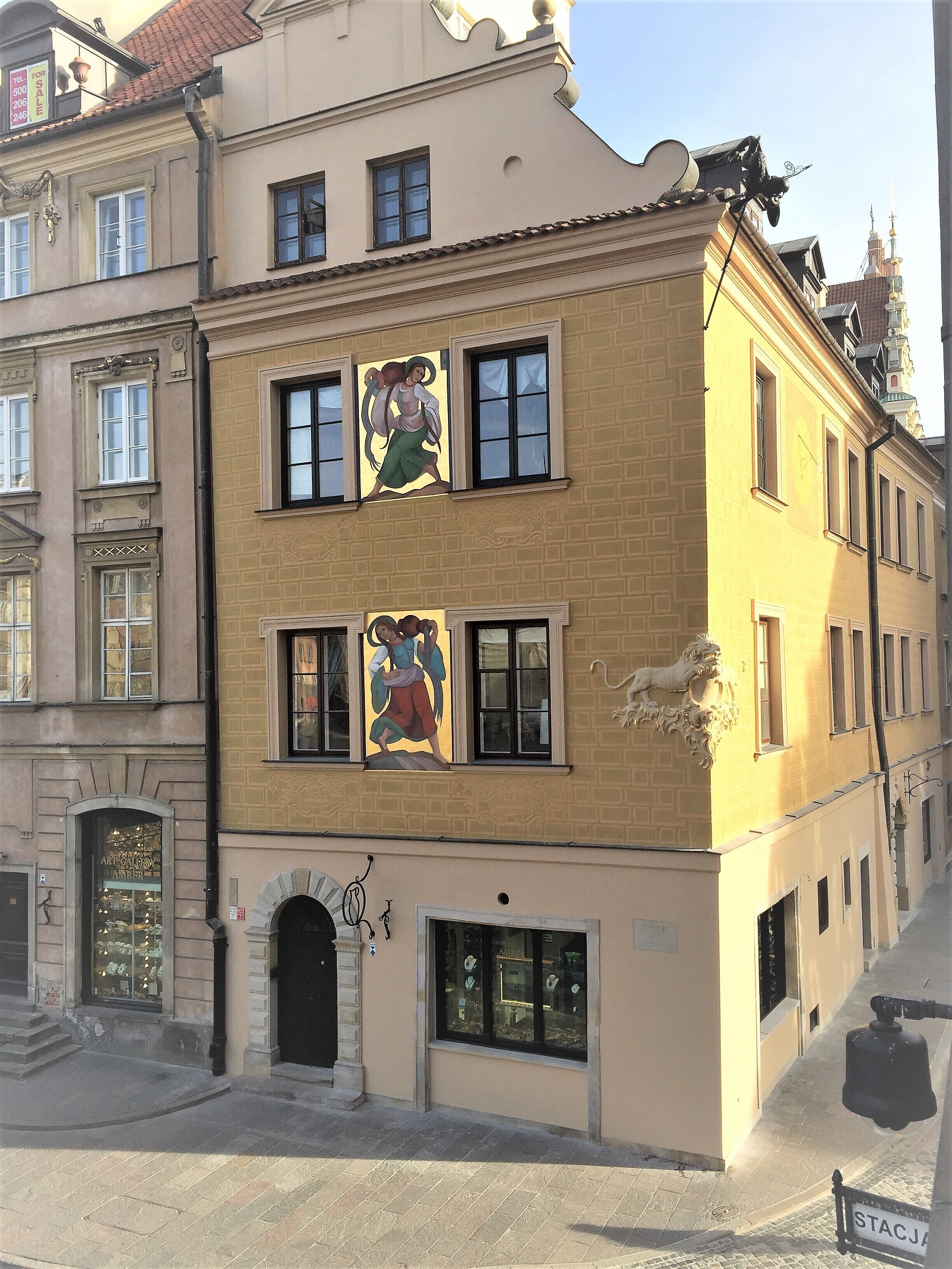A building with a ground-floor shop and upper-floor residential units.