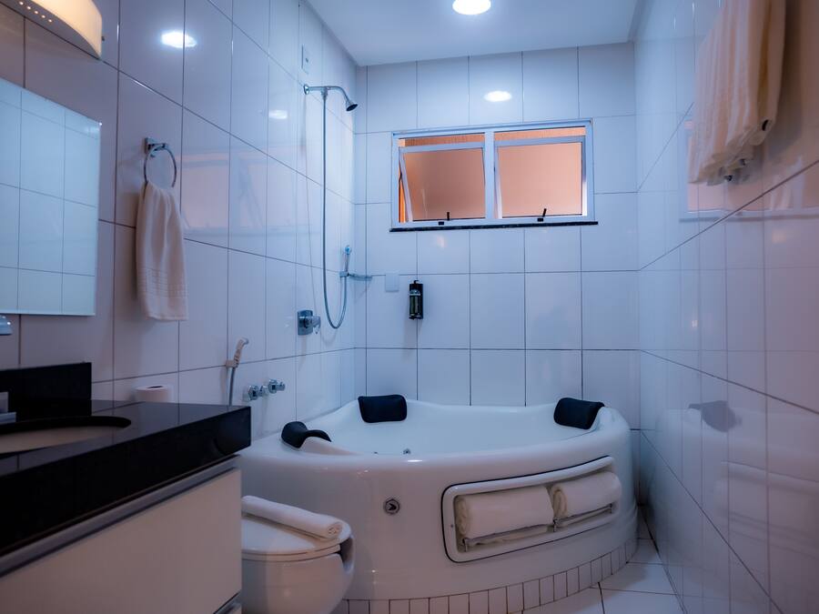 A modern bathroom with a bathtub, toilet, and sink.