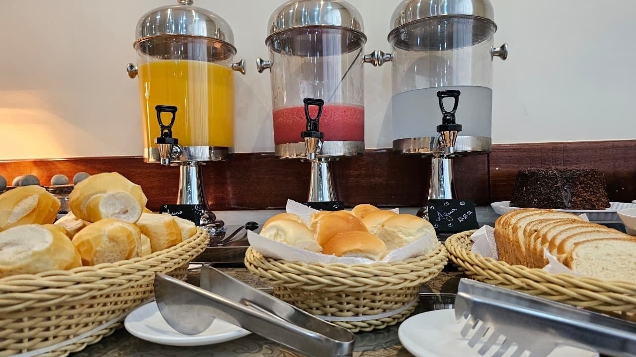 A breakfast buffet with various food items and a coffee station.